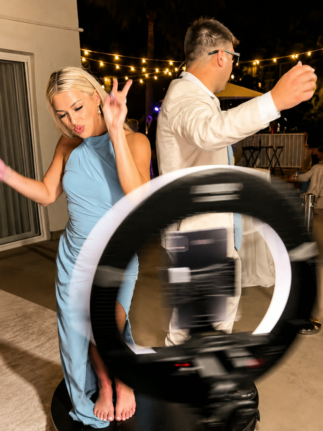 Guests posing as the 360 camera arm spins around the platform