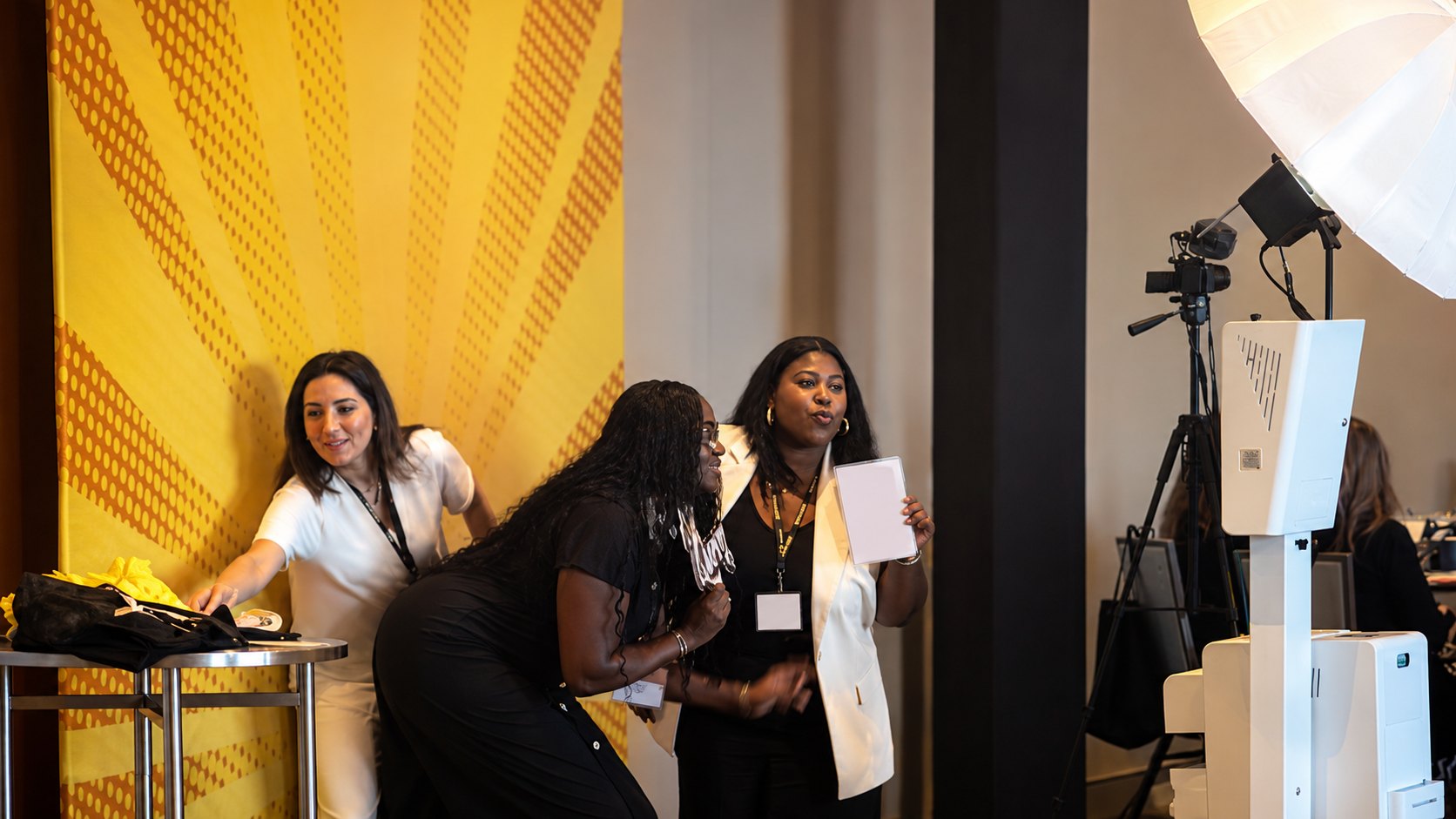 Guests enjoying the SnapJoy branded photo booth activation at the 2026 WOCAN Annual Event in Miami Beach.