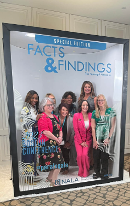 Conference attendees posing inside a special edition magazine cover set
