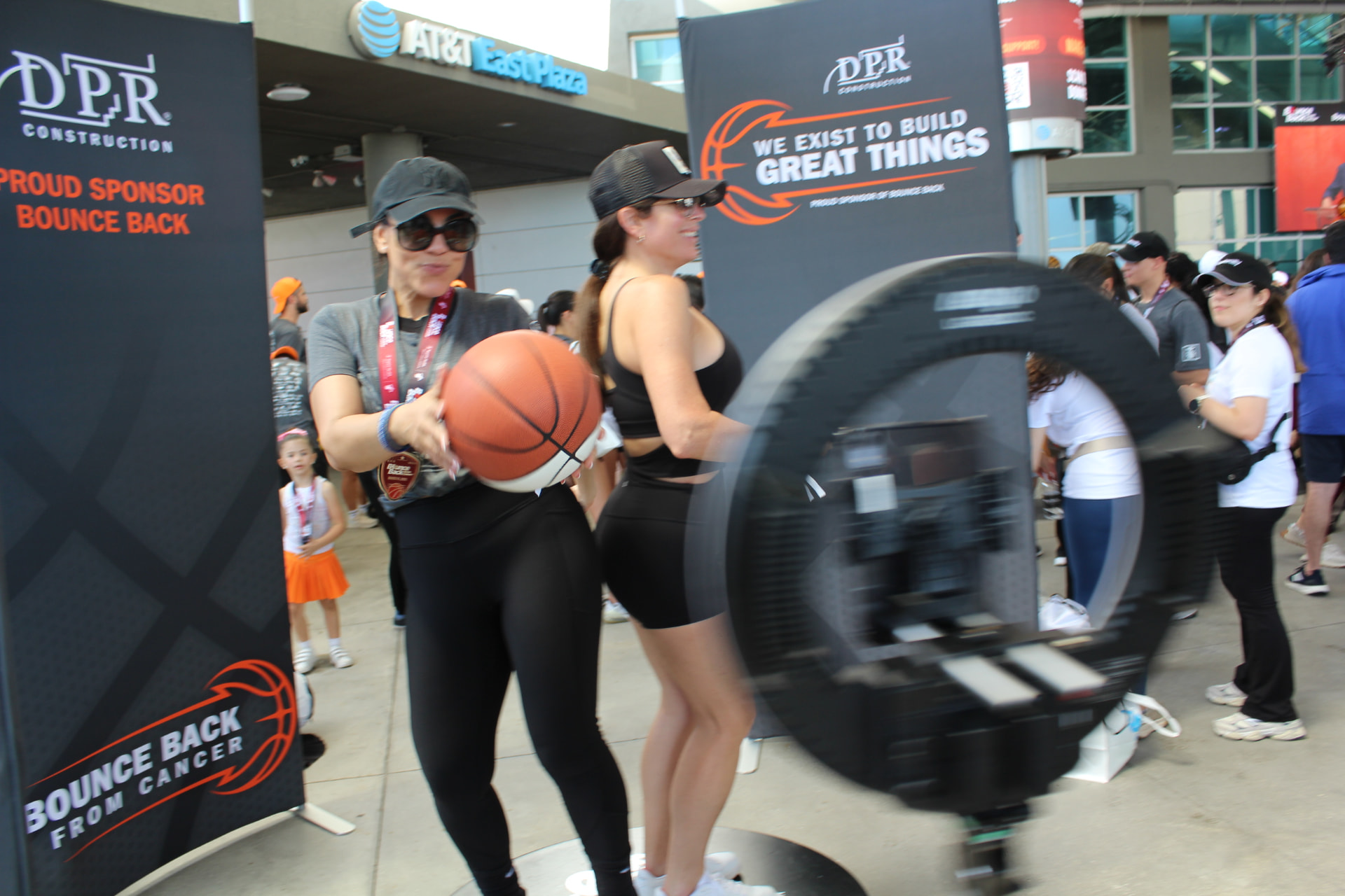 The 360 camera arm sweeping around guests holding basketballs inside the Pavilion