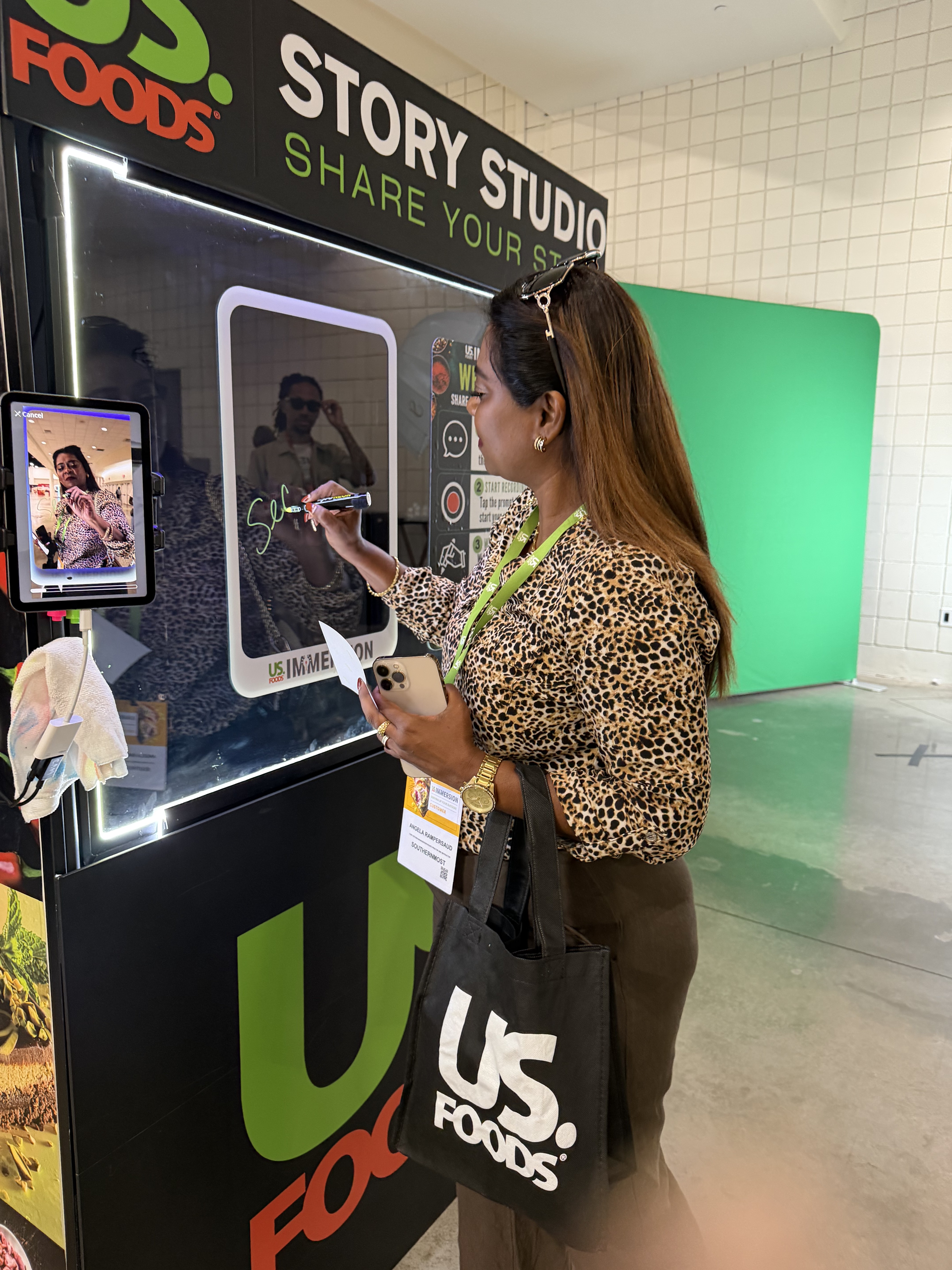 Guest writing a message inside the US Foods Story Studio by SnapJoy