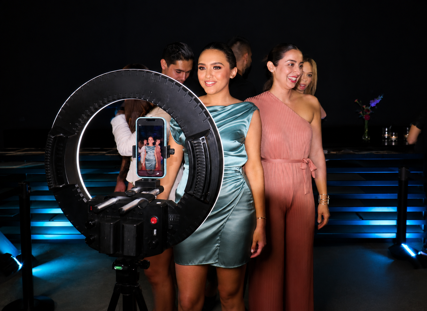 Guests posing for a 360 video booth with ring light at a corporate event