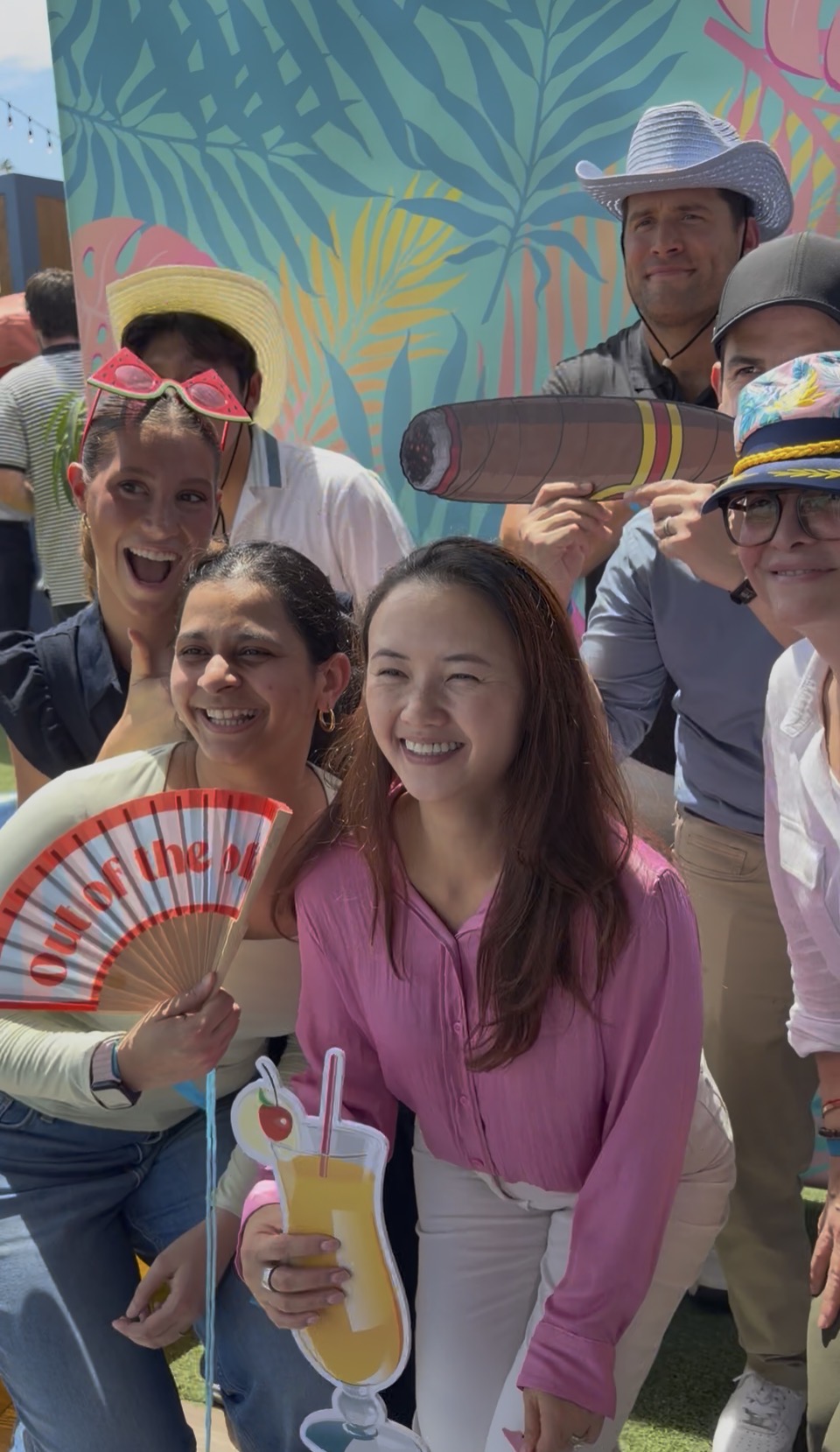 Guests using playful summer props at the photo booth