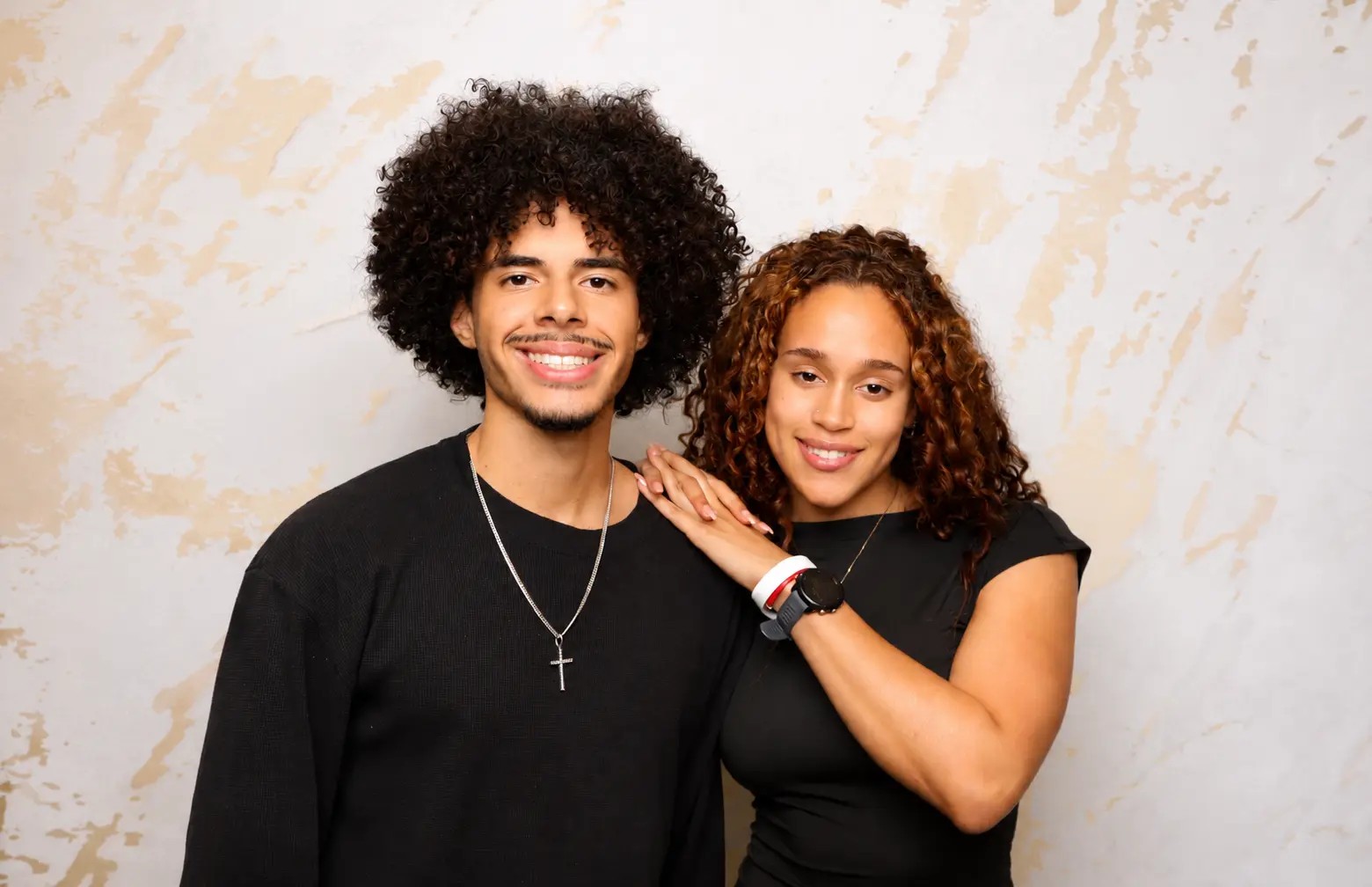 Couple posing for a polished portrait in the booth
