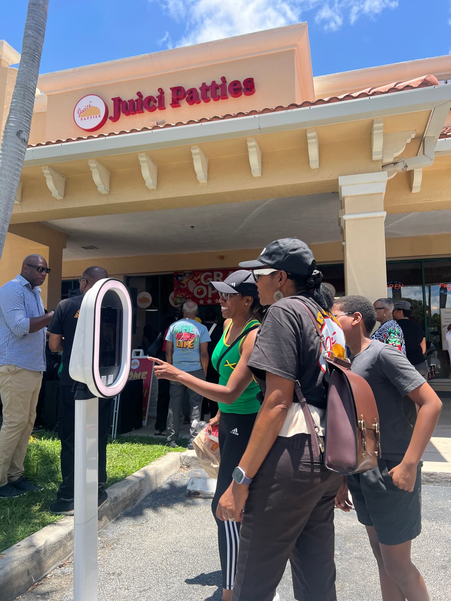 Guest tapping the SnapBar touchscreen during the Juici Patties grand opening