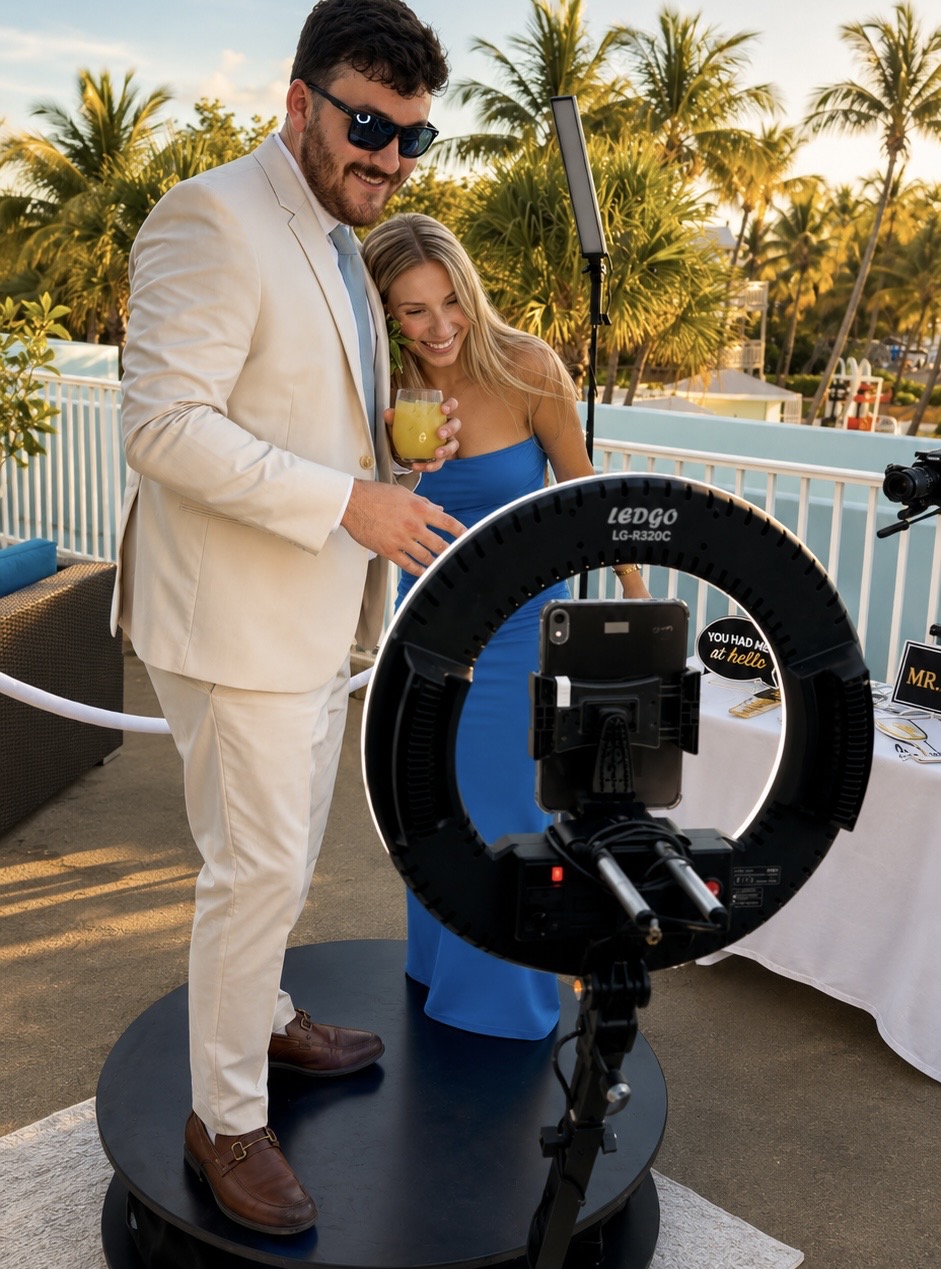 Couple on a 360 video booth platform at sunset