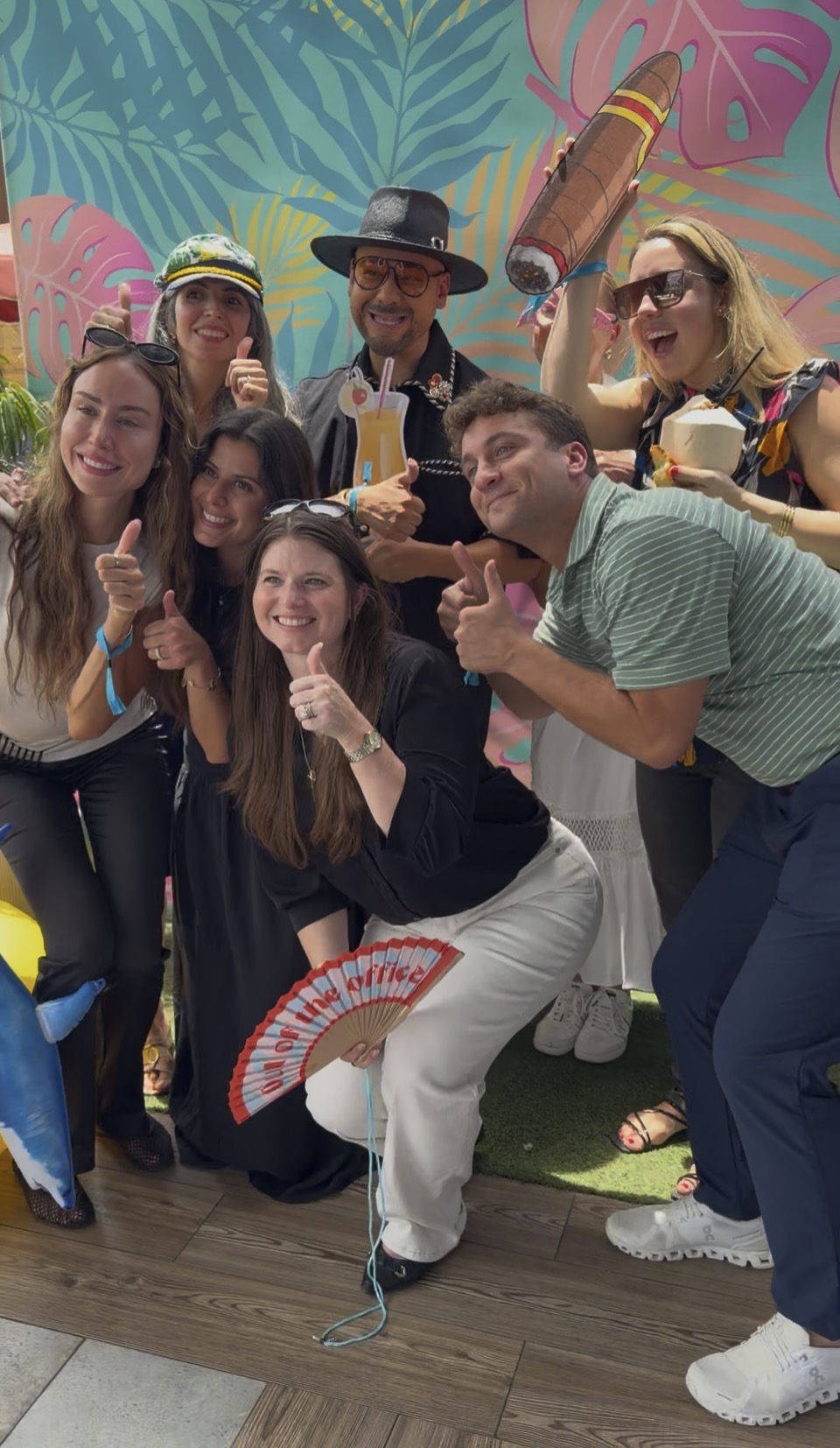 Colleagues posing together with summer props