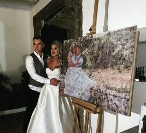 Wedding couple beside a canvas photo mosaic of their portrait