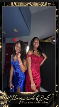Two students in blue and red formal gowns posing side by side on the 360 platform
