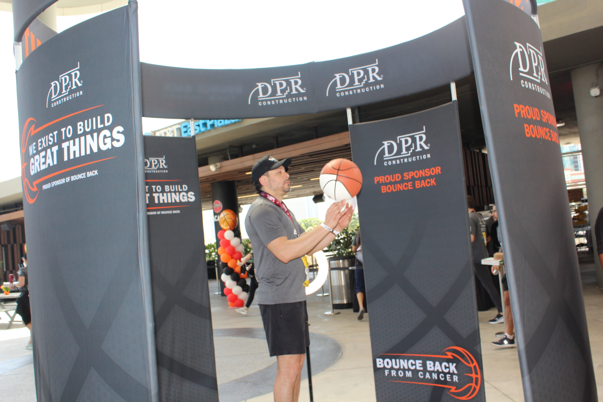 A participant spinning a basketball inside the DPR Construction branded 360 Pavilion