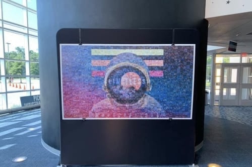 Finished branded photo mosaic displayed at a convention center