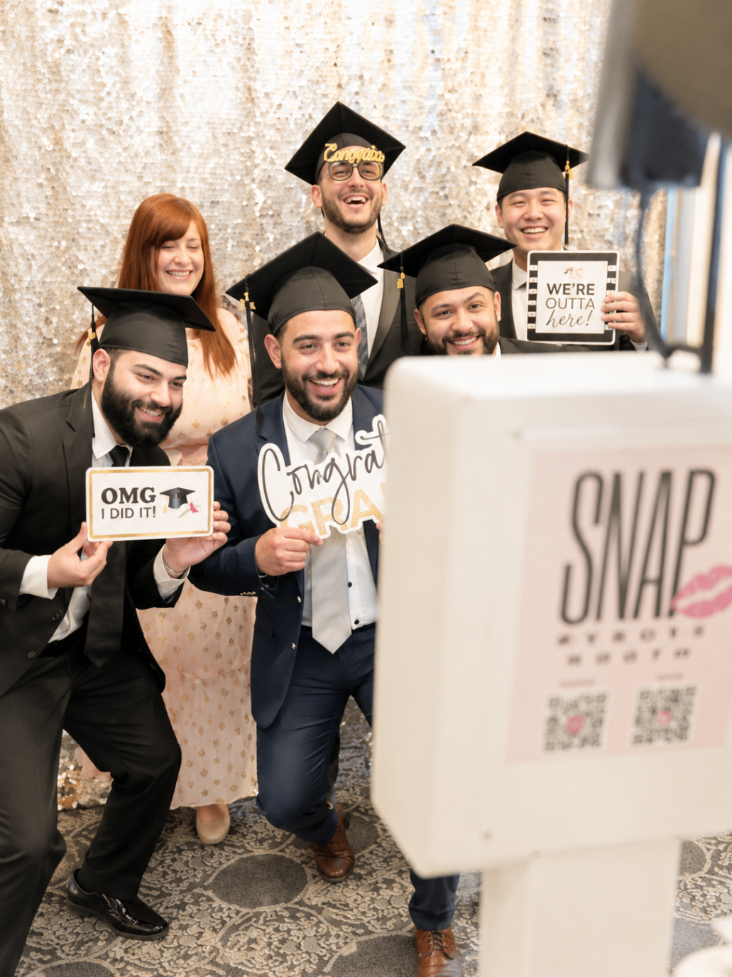 Graduating friends celebrating together at SnapJoy booth