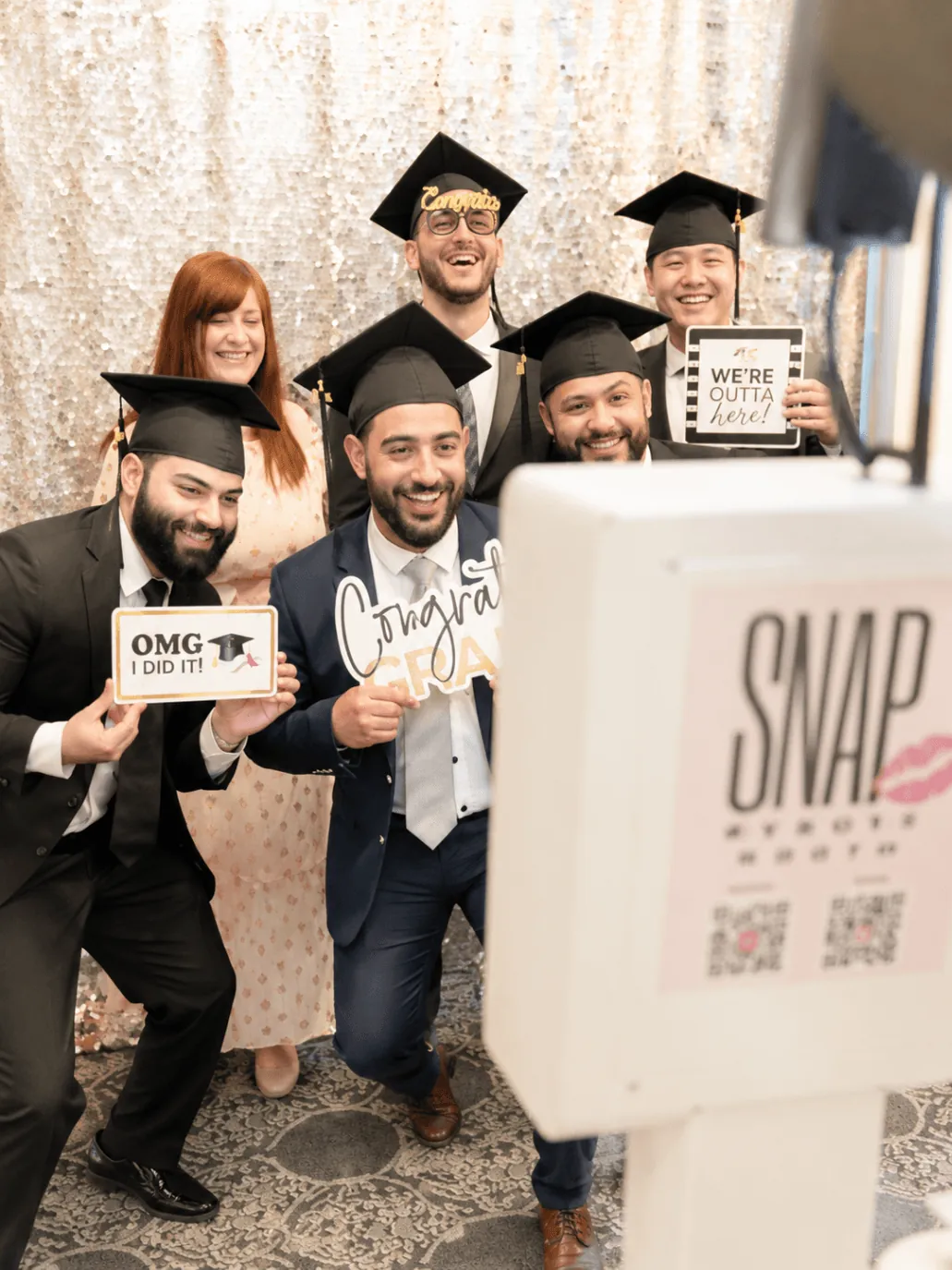 Graduating friends celebrating together at SnapJoy booth