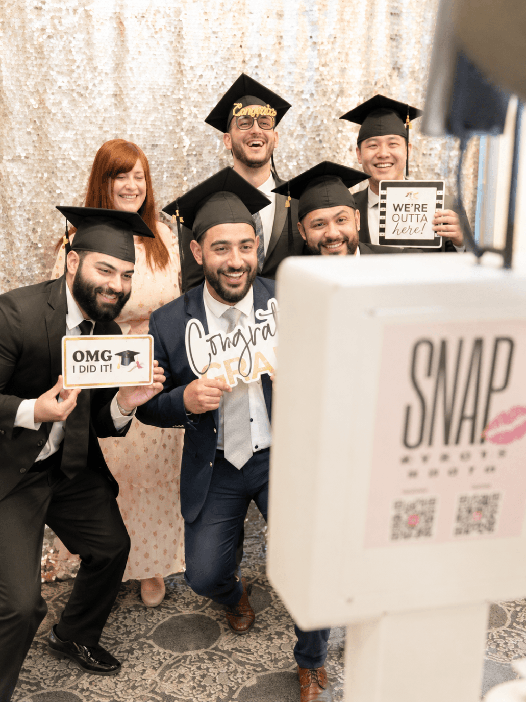 Graduating friends celebrating together at SnapJoy booth