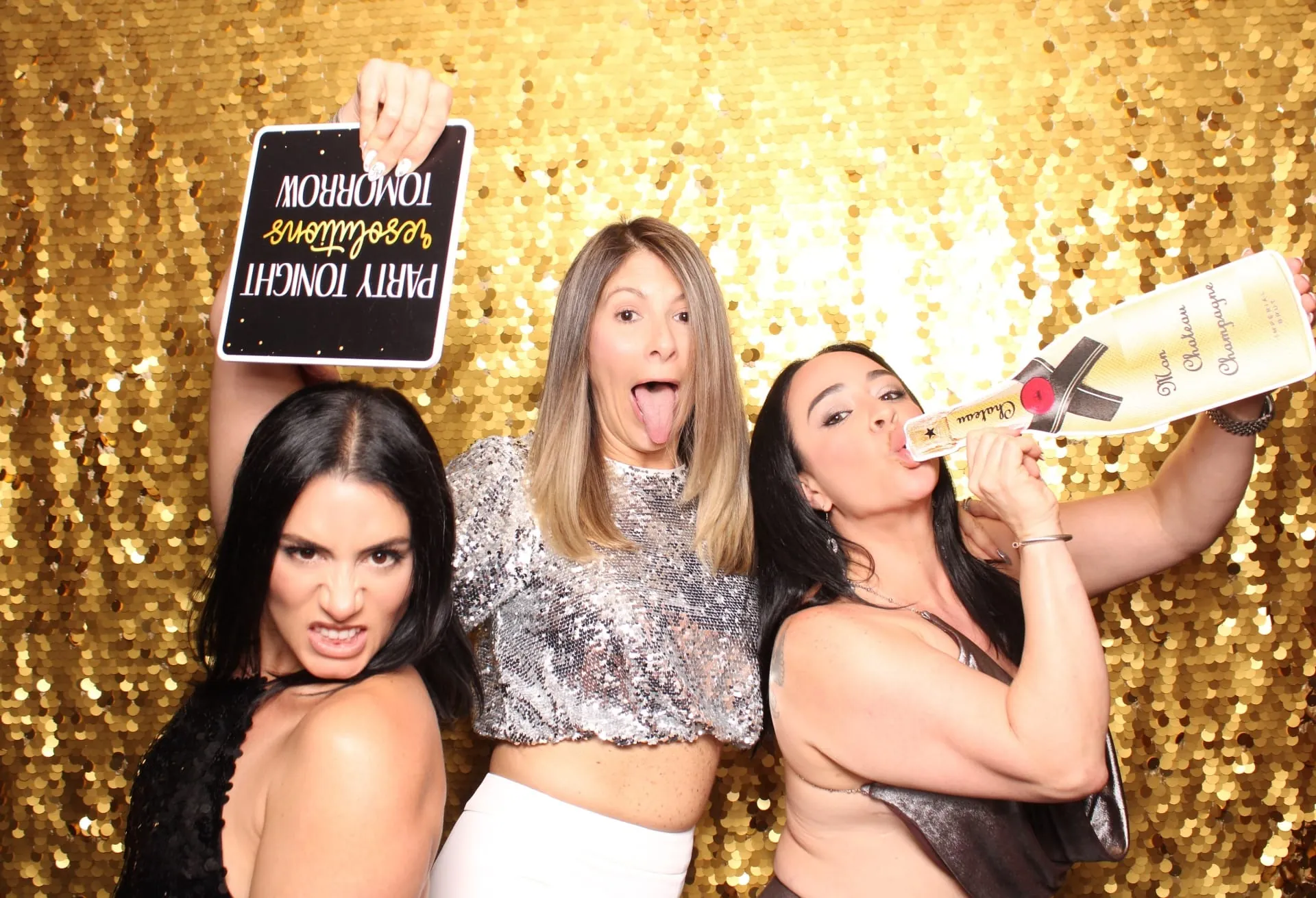 Three women with Party Tonight Resolutions Tomorrow sign