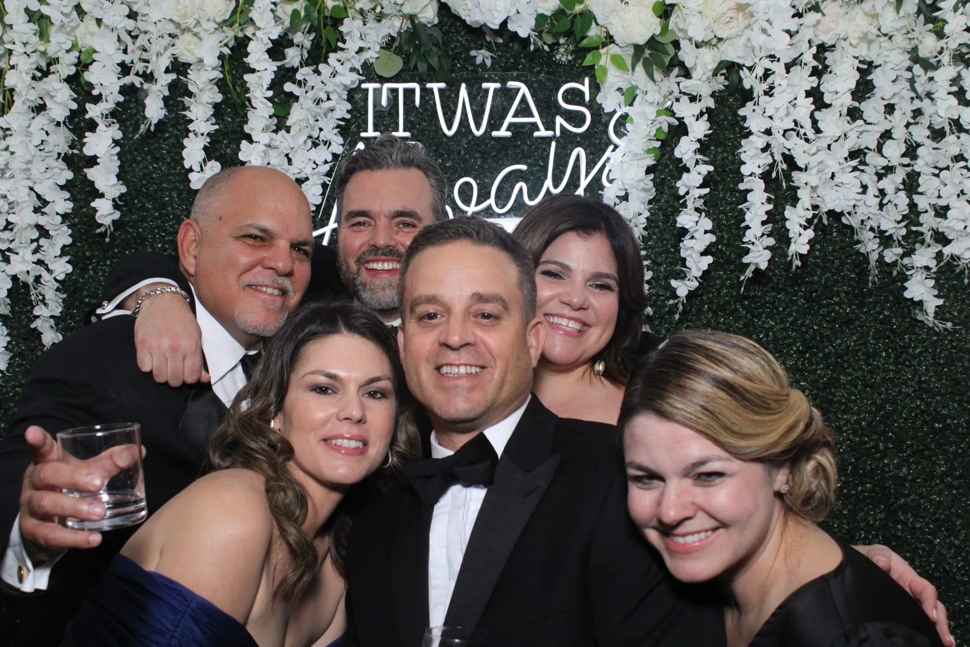 Group portrait in front of the greenery wall
