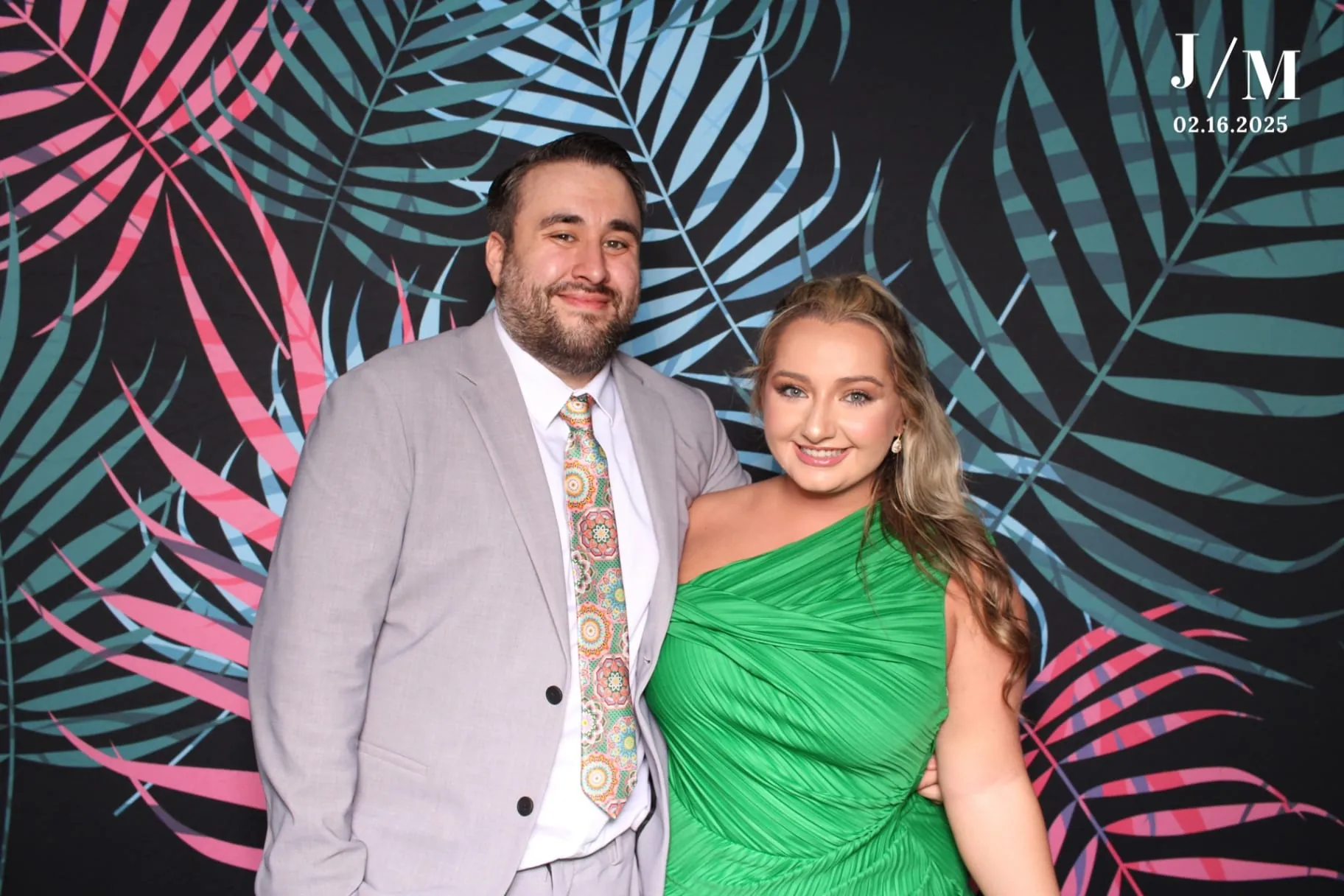 Couple smiling on tropical palm backdrop