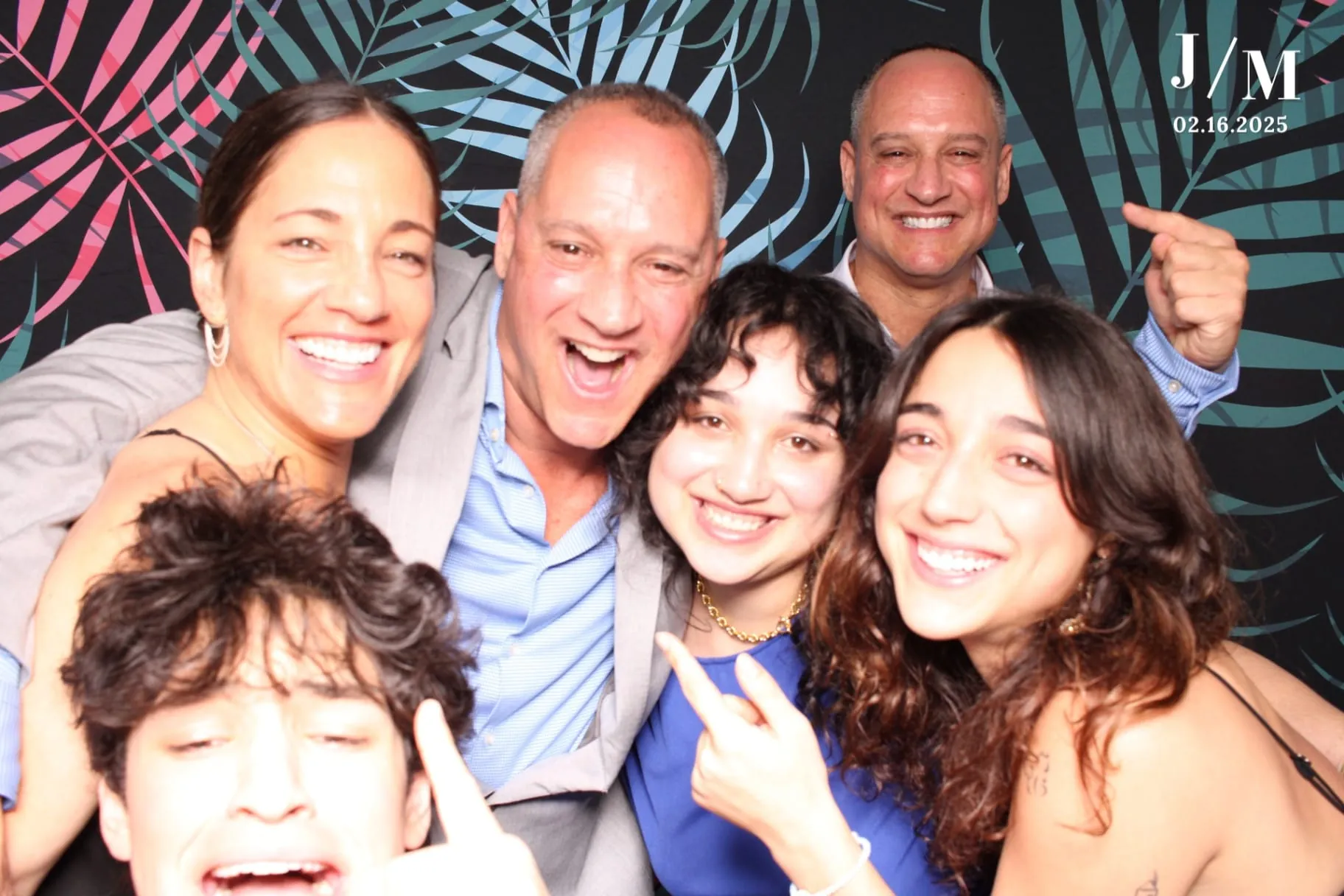Family group laughing on tropical palm backdrop