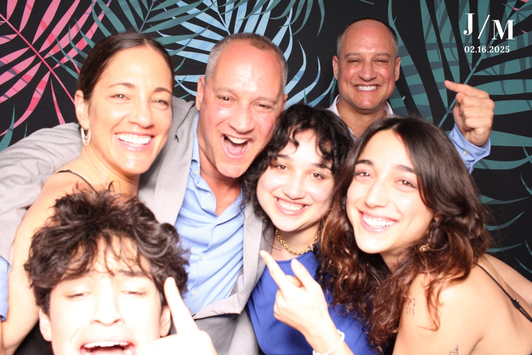 Family group laughing on tropical palm backdrop